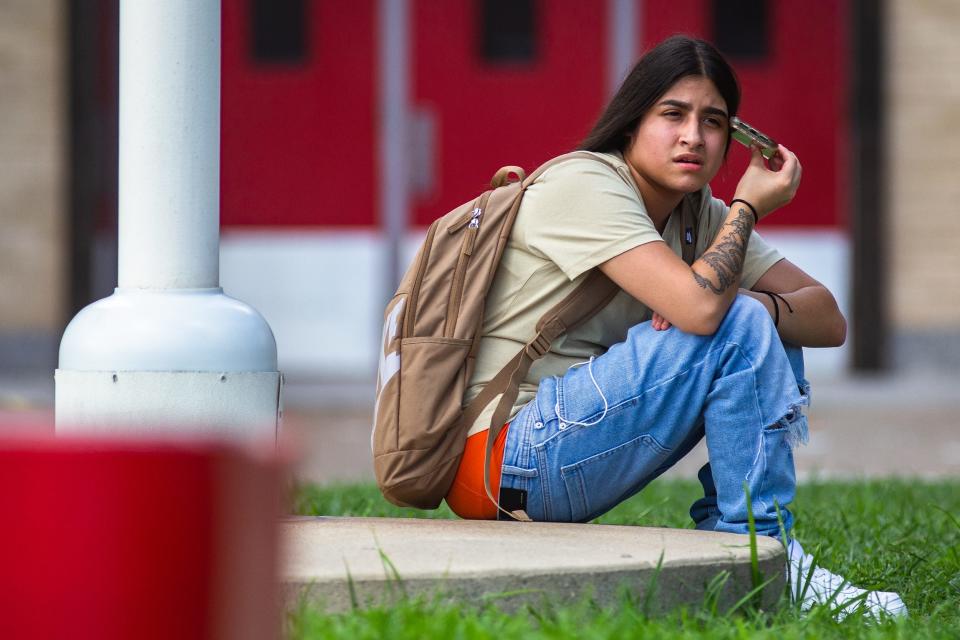 Seventeen-year-old Ray High School junior Amaris Sanchez talks on the phone outside the school after police responded to a false report of an active shooter on Friday, Sept. 16, 2022. The report prompted a lockdown before police determined it was false, and students were released early.