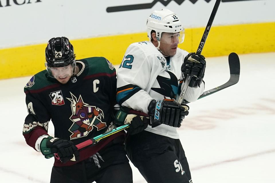 San Jose Sharks left wing Patrick Marleau (12) battles with Arizona Coyotes defenseman Oliver Ekman-Larsson (23) for position during the first period of an NHL hockey game Thursday, Jan. 14, 2021, in Glendale, Ariz. (AP Photo/Ross D. Franklin)