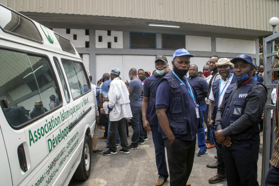 Colleagues of World Food Programme (WFP) driver Moustapha Milambo, who was killed in the attack on a U.N. convoy that also killed the Italian ambassador to Congo and an Italian Carabinieri police officer, wait to receive his body at the morgue in Goma, North Kivu province, Congo Tuesday, Feb. 23, 2021. An Italian Carabinieri unit is expected in Congo Tuesday to investigate the killings of the Italian ambassador to Congo, an Italian Carabinieri police officer and their driver in the country's east. (AP Photo/Justin Kabumba)