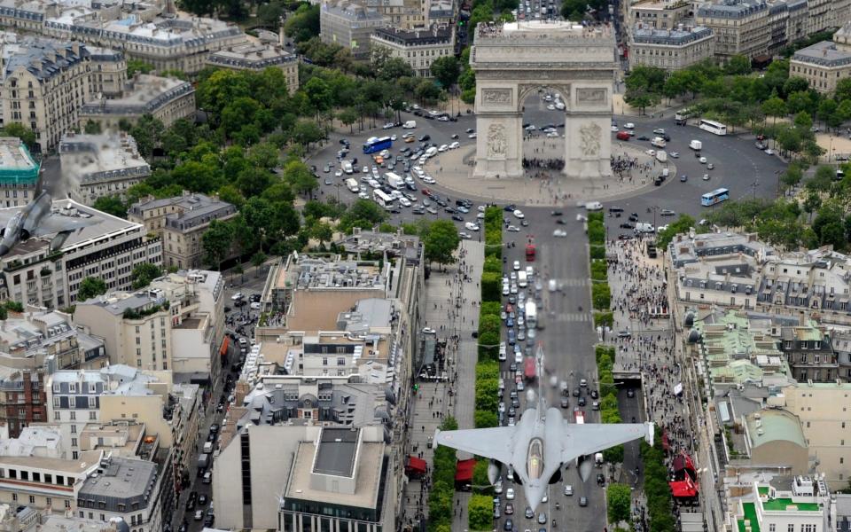 France's Rafale jet flying over the Arc de Triomphe - ANNE-CHRISTINE POUJOULAT/AFP