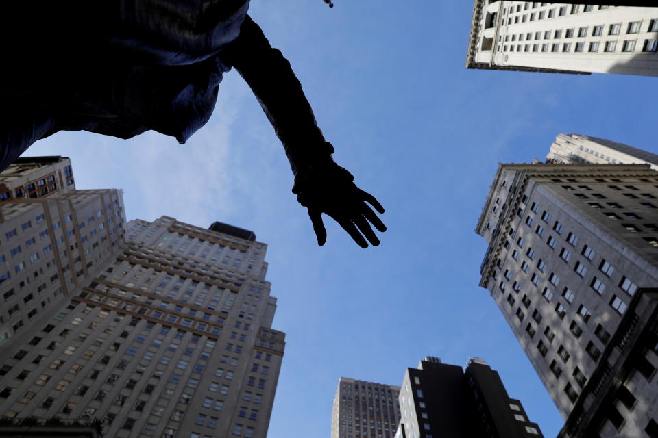 The hand of a sculpture of former U.S. President George Washington is pictured with the facade of the New York Stock Exchange (NYSE) building after the start of Thursday's trading session in Manhattan in New York City, New York, U.S., January 28, 2021. REUTERS/Mike Segar     TPX IMAGES OF THE DAY