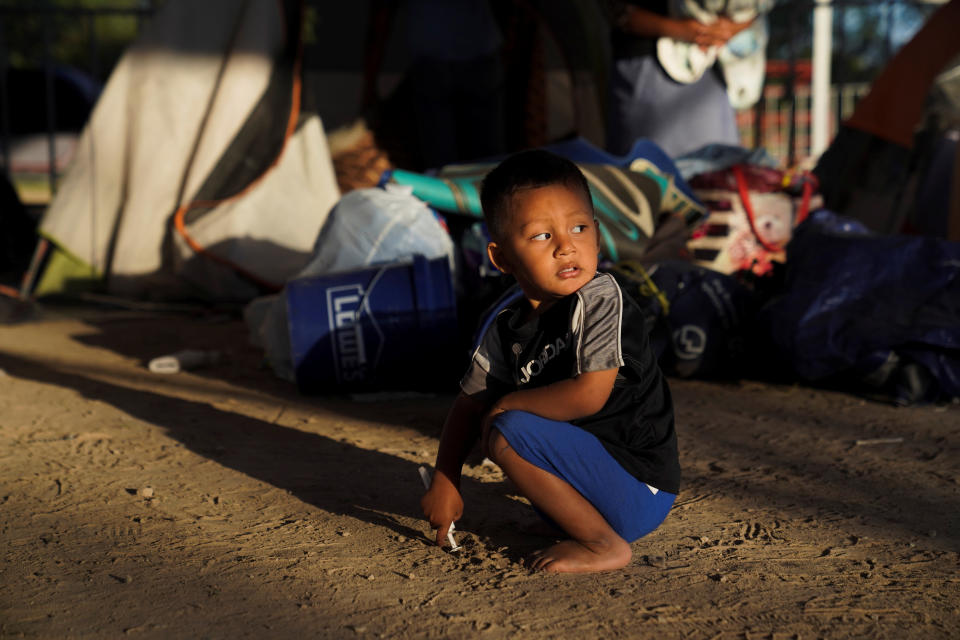 Elias, 2, a Honduran asylum-seeking child, plays near the tent where he lives after being relocated from the plaza near the Gateway International Bridge in Matamoros, Mexico, on Dec. 7, 2019. (Photo: Veronica Cardenas / Reuters)