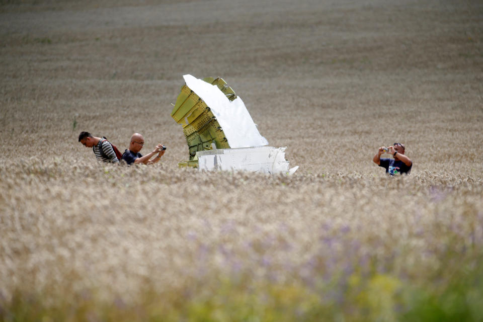 Malaysian air crash investigators take photos of the crash site of Malaysia Airlines Flight MH17, near the village of Hrabove (Grabovo), Donetsk region July 22, 2014. The Dutch are due to announce on Wednesday 28 September the long-awaited results of an investigation with Australia, Malaysia, Belgium and Ukraine into the July 17, 2014 downing of the flight.  REUTERS/Maxim Zmeyev/File Photo          FROM THE FILES PACKAGE - SEARCH "FILES MH17" FOR ALL 20 IMAGES