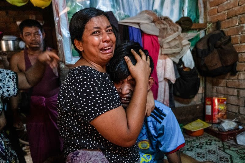 Family members mourn a man after he was shot dead during anti-coup protests, in Yangon