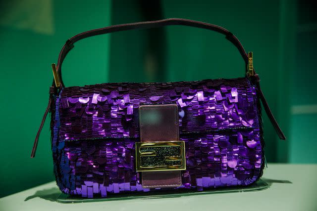 <p>Getty Images</p> Carrie Bradshaw's Fendi Baguette on view during the "Bags: Inside Out" exhibit at the Victoria and Albert Museum in London