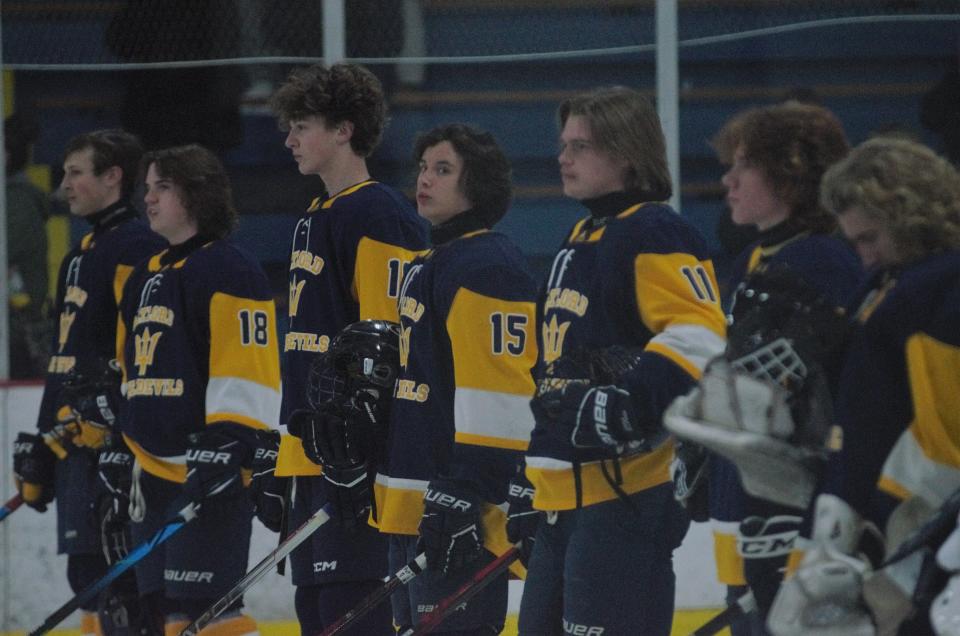 The Gaylord hockey team listens to the national anthem prior to a high school hockey matchup between Gaylord and Grosse Ile on Friday, December 9 during the Division 3 Showcase in Gaylord, Mich.