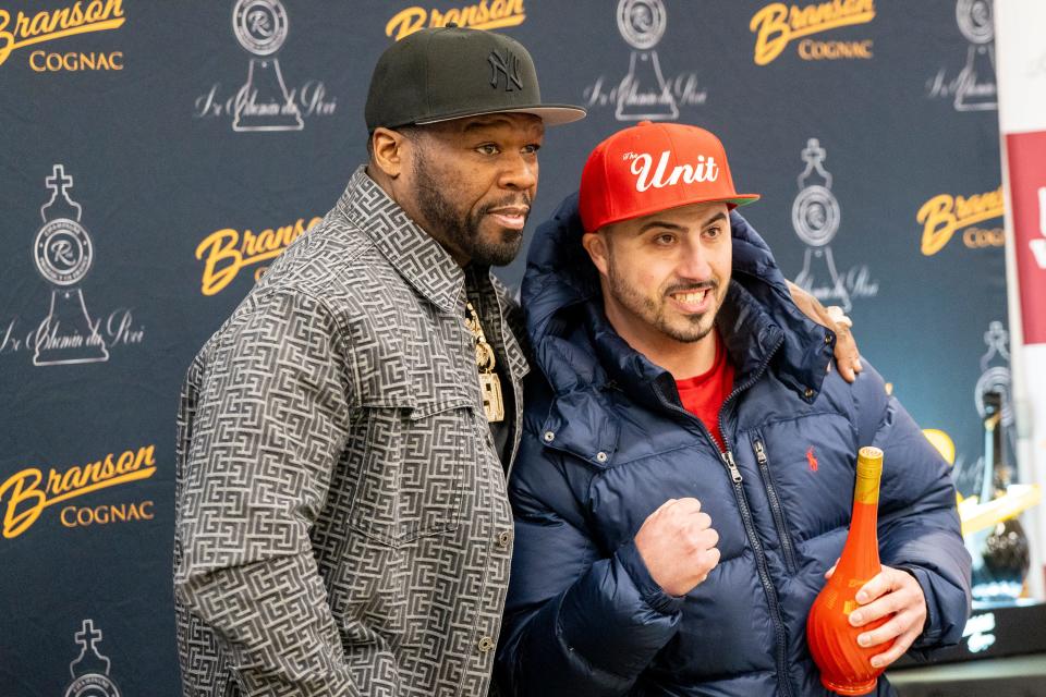 Feb 21, 2024; Paramus, NJ, USA; Lou Topchev from North Arlington has his photo taken with musician and entrepreneur Curtis '50 Cent' Jackson during a meet and greet and bottle signing featuring his Branson Cognac and Chemin du Roi champagne at Stew Leonard's on Wednesday.