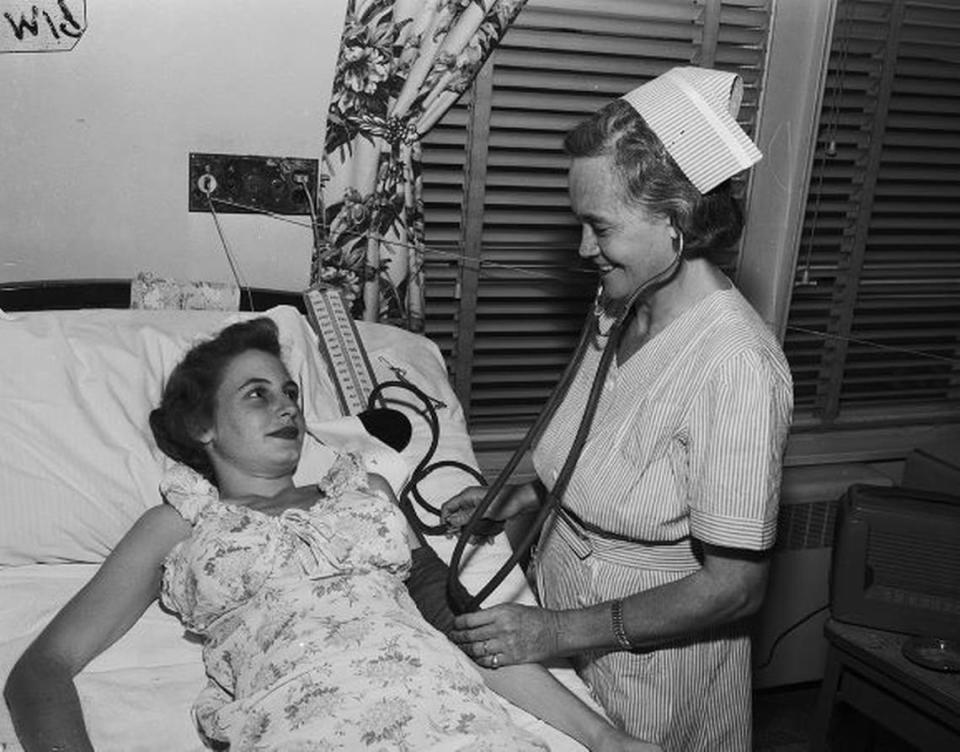 1950: Mrs. Lillie Belle Grimland, one of the first graduates of the Practical Nursing Program of the Fort Worth Public Schools, is skilled in bedside technique. She is shown taking the blood pressure of Mrs. E. E. Bell, 1417 Richmond, a patient at Harris Hospital.