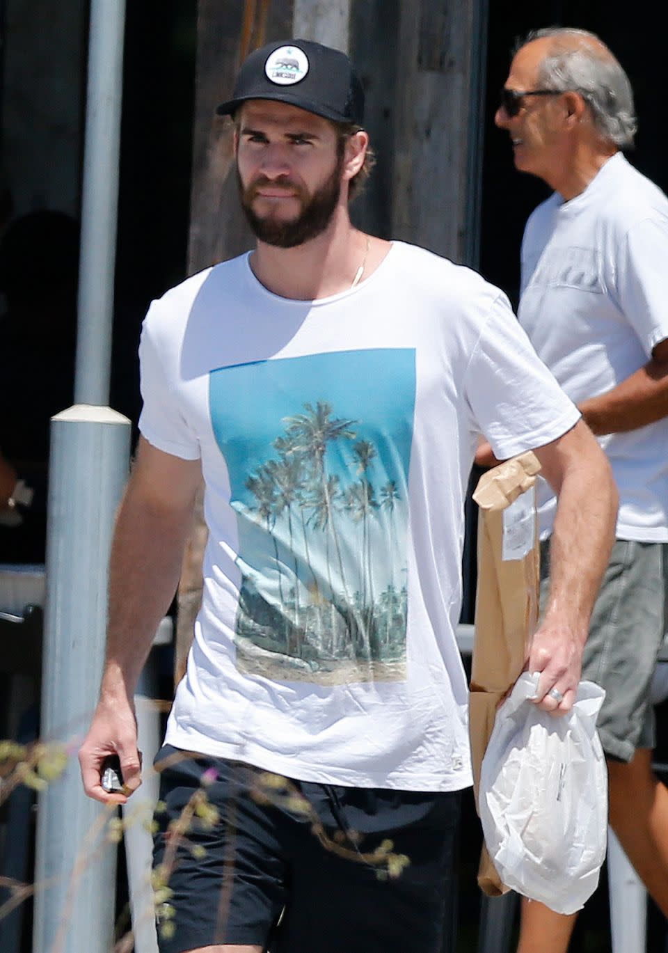 The younger brother of actor Chris Hemsworth holds onto some purchases from his grocery run. Source: Mega