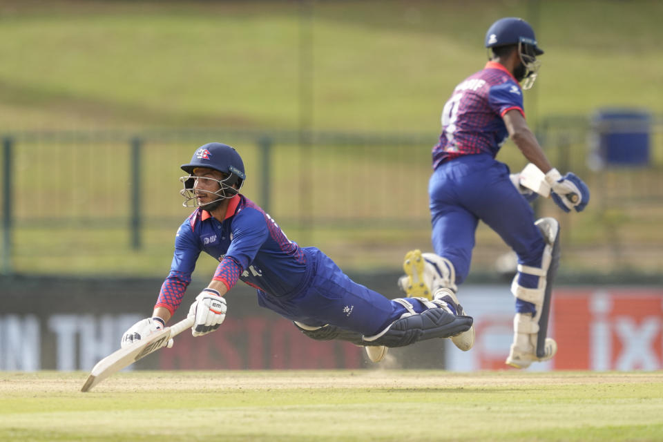 Nepal's Bhim Sharki, left, successfully completes a run during the Asia Cup cricket match between India and Nepal in Pallekele, Sri Lanka on Monday, Sep. 4. (AP Photo/Eranga Jayawardena)