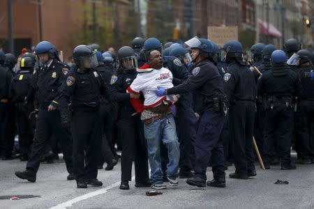 Police detain a protester at a rally to protest the death of Freddie Gray who died following an arrest in Baltimore, Maryland April 25, 2015. REUTERS/Shannon Stapleton