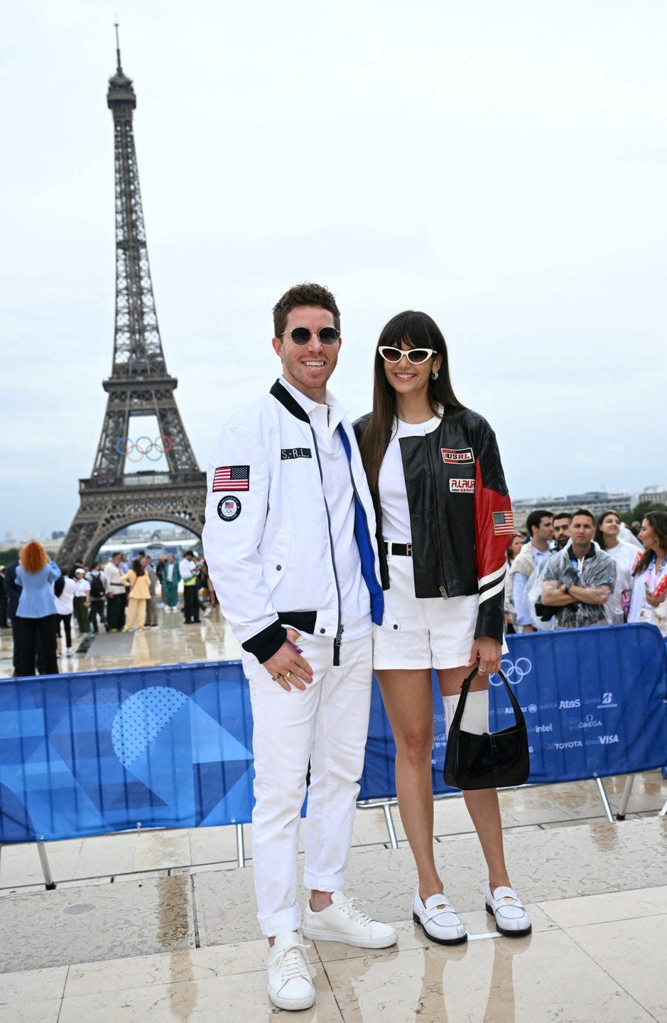 former us snowboarder shaun white and his partner canadian actress nina dobrev arrives ahead of the opening ceremony of the paris 2024 olympic games in paris on july 26, 2024, as the eiffel tower is seen in the background photo by jonathan nackstrand afp photo by jonathan nackstrandafp via getty images