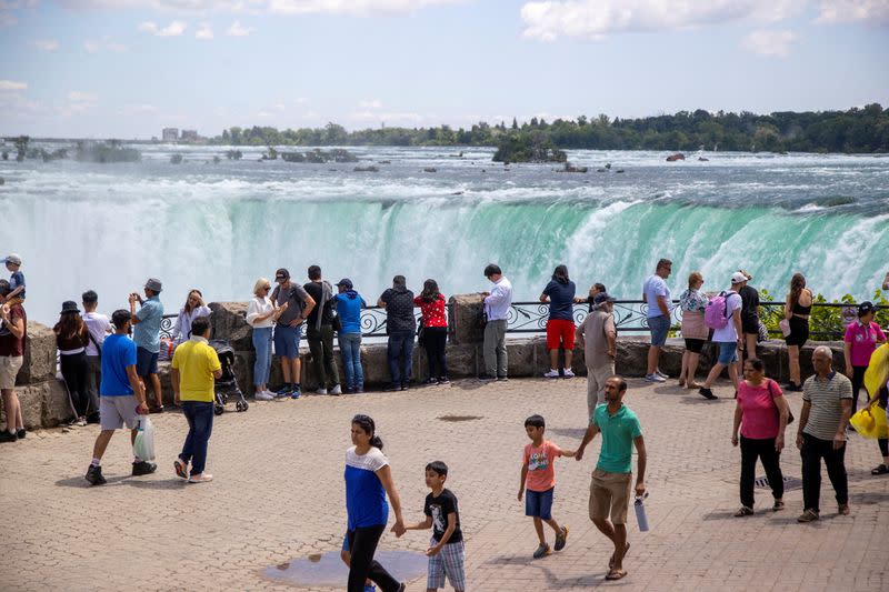 FILE PHOTO: Tourist take photos in front of the Horsehoe Falls in Niagara Falls