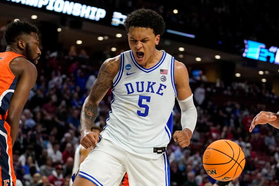 Duke's Paolo Banchero, center, reacts after scoring during the first half of a college basketball game in the first round of the NCAA tournament against Cal State Fullerton Friday, March 18, 2022, in Greenville, S.C. (AP Photo/Brynn Anderson)