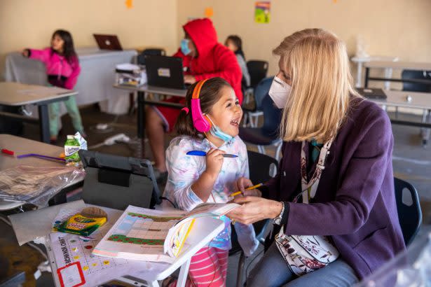 Volunteer Jill Ause helps a 5-year-old kindergartner learn about sounds and the letters of the alphabet at a learning pod for homeless children, located in the carport at the Hyland Motel in Van Nuys, California. (Mel Melcon / Getty Images)