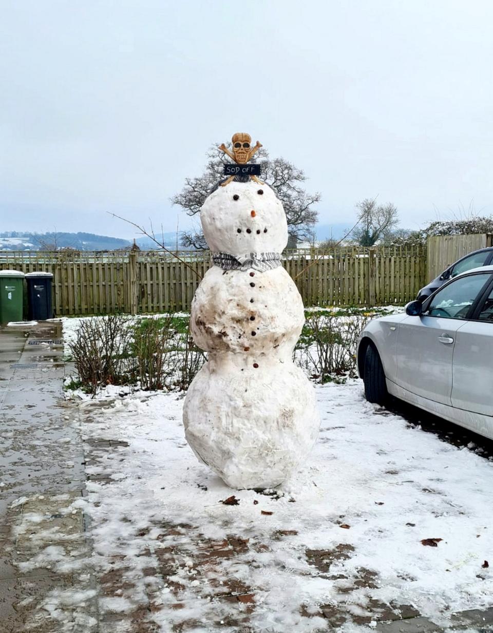 Three-year-old Joseph Taylor was left in floods of tears after watching a grinning binman boot the head off his 6ft-tall snowman (SWNS)