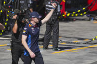 Red Bull driver Max Verstappen of the Netherlands gestures to fans after retiring from the Australian Formula One Grand Prix at Albert Park, in Melbourne, Australia, Sunday, March 24, 2024. (AP Photo/Scott Barbour,Pool)