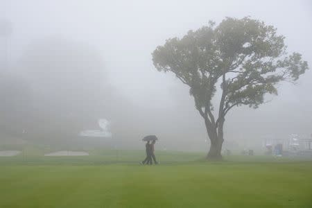 February 14, 2019; Pacific Palisades, CA, USA; Spectators walk along the second course fairway during a stoppage in play in the first round of the Genesis Open golf tournament at Riviera Country Club. Mandatory Credit: Gary A. Vasquez-USA TODAY Sports