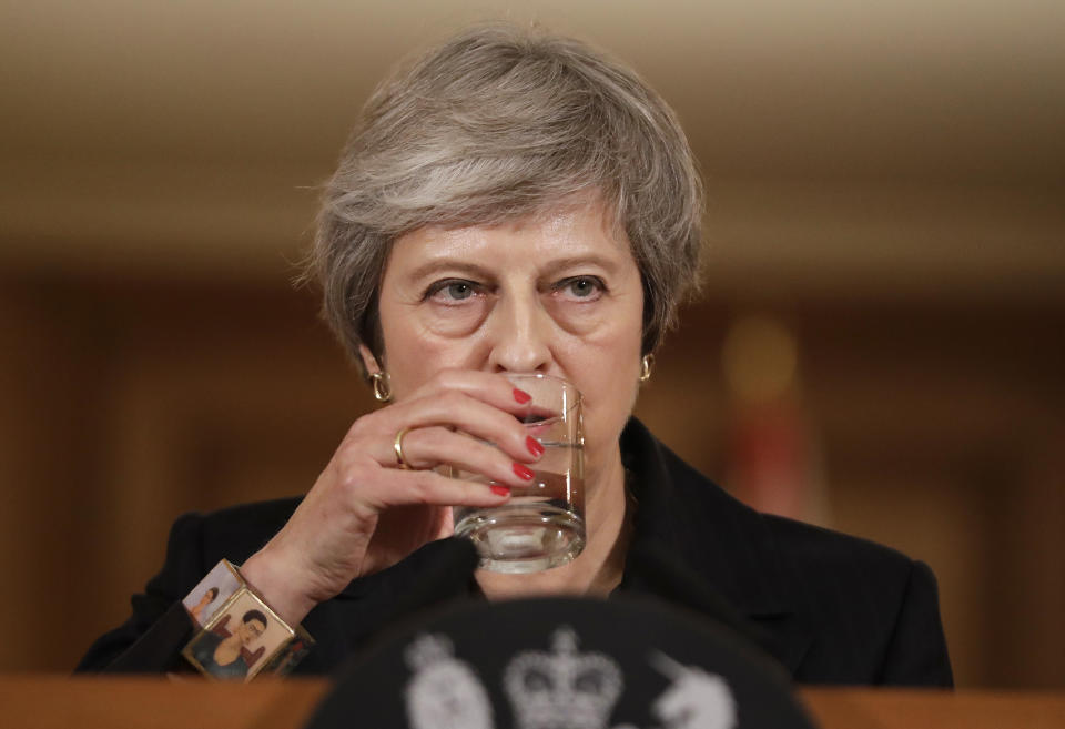 Britain's Prime Minister Theresa May takes a drink of water during a press conference inside 10 Downing Street in London, Thursday, Nov. 15, 2018. Two British Cabinet ministers, including Brexit Secretary Dominic Raab, resigned Thursday in opposition to the divorce deal struck by Prime Minister Theresa May with the EU — a major blow to her authority and her ability to get the deal through Parliament. (AP Photo/Matt Dunham, Pool)