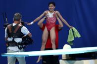 <p>Team China's Hongchan Quan gets lifted up in the air after winning gold in the Women's 10m Platform Final at Tokyo Aquatics Centre on August 5.</p>