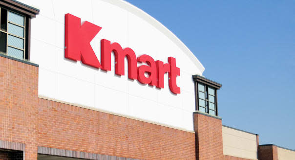 A lone shopper enters a K mart retail store, one of many corporate outlet stores throughout the nation. Elmhurst, Illinois.