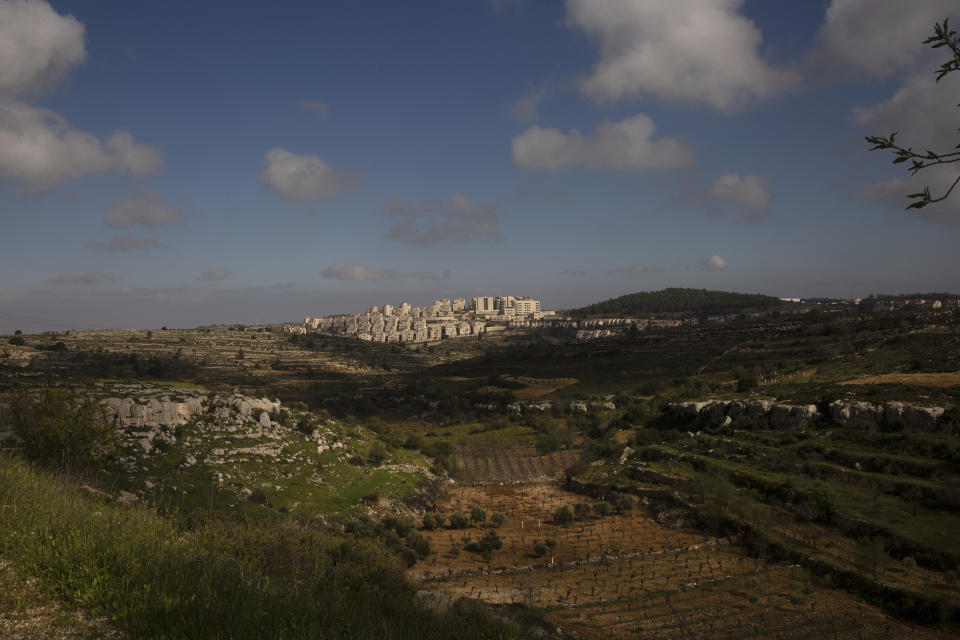 Sunlight peeks through clouds over a section of the West Bank Jewish settlement of Efrat, March 12, 2021. Israel went on an aggressive settlement spree during the Trump era, according to an AP investigation, pushing deeper into the occupied West Bank than ever before and putting the Biden administration into a bind as it seeks to revive Mideast peace efforts. (AP Photo/Maya Alleruzzo)