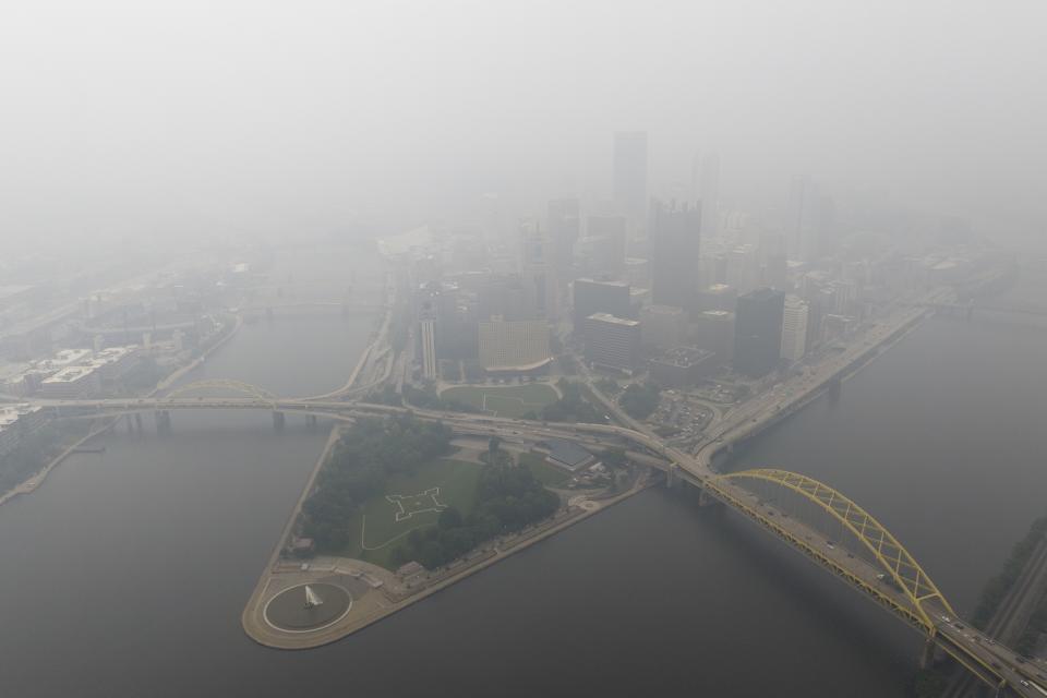 FILE - Haze from Canadian wildfires blankets the downtown Pittsburgh skyline as seen from Elliott, Pa., June 28, 2023. As smoky as the summer has been so far, scientists say it will likely be worse in future years because of climate change. (Benjamin B. Braun/Pittsburgh Post-Gazette via AP)/Pittsburgh Post-Gazette via AP)