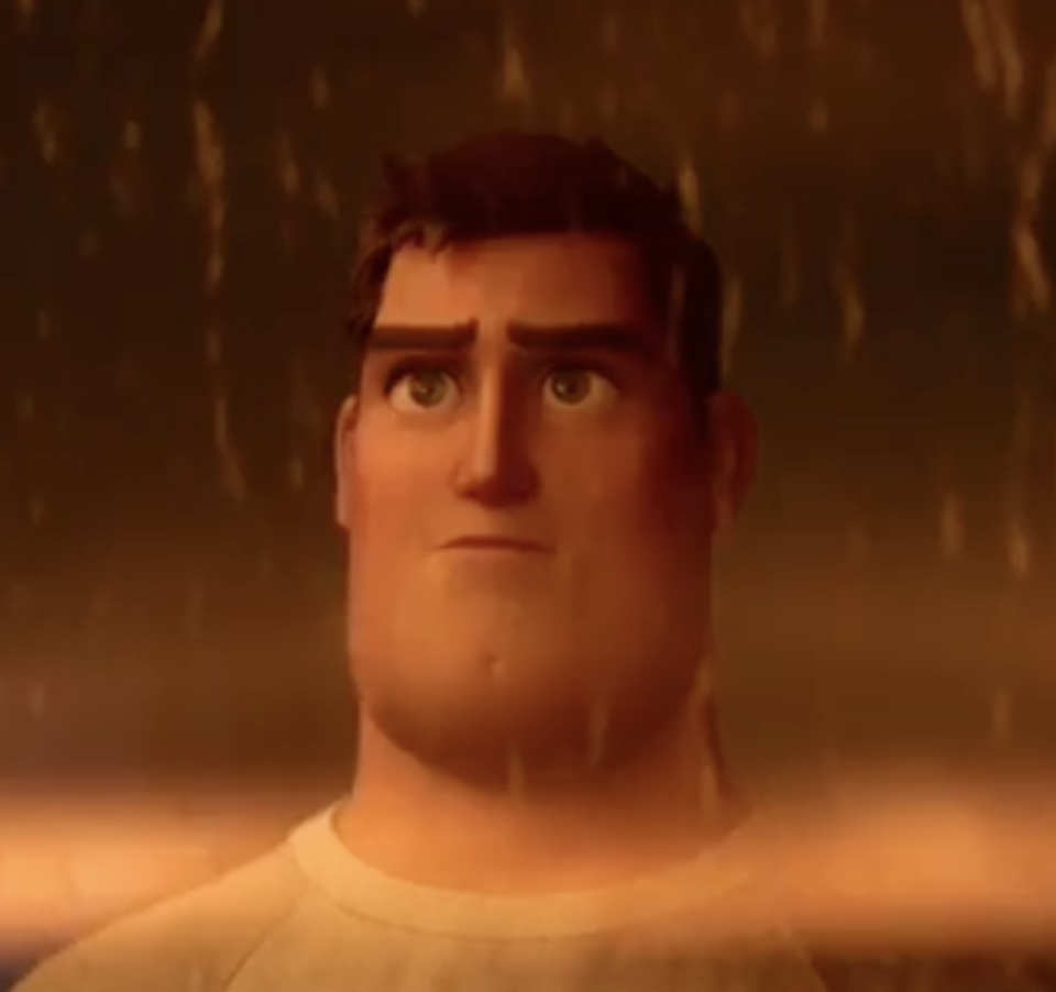 Photo of BUzz looking out of a window while it rains, he's wearing a white t-shirt and hair is showing