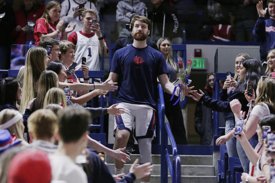 Gonzaga forward Drew Timme, center, greets fans in the student section during a senior night ceremony before the team's NCAA college basketball game against Chicago State, Wednesday, March 1, 2023, in Spokane, Wash. (AP Photo/Young Kwak)