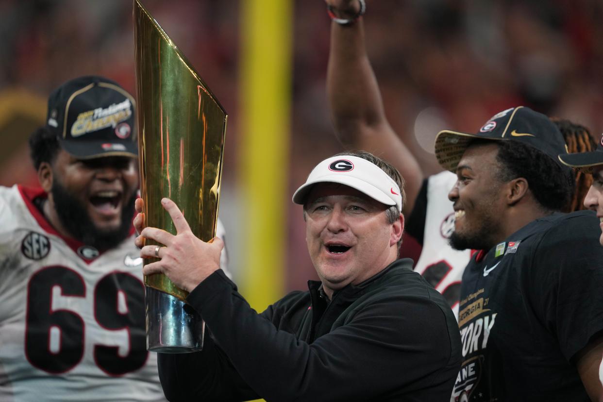 Jan 10, 2022; Indianapolis, IN, USA; Georgia head coach Kirby Smart holds the National Championship trophy after defeating the Alabama Crimson Tide in the 2022 CFP college football national championship game at Lucas Oil Stadium. Kirby Lee-USA TODAY Sports