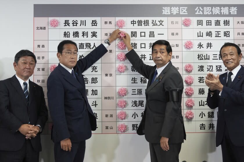 Fumio Kishida, second left, Japan's prime minister and president of the Liberal Democratic Party (LDP), speaks after placing a red paper rose on an LDP candidate's name, to indicate a victory in the upper house election, at the party's headquarters in Tokyo, Japan, on Sunday, July 10, 2022. (Toru Hanai, Pool Photo via AP)