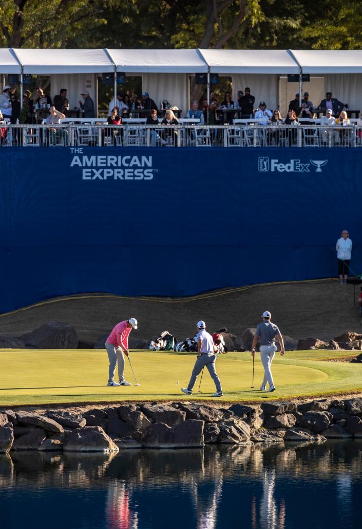 Taylor Montgomery (from left), Dylan Wu and Sam Burns play the 17th green during the final round of The American Express on the Pete Dye Stadium Course at PGA West in La Quinta, Calif., Sunday, Jan. 22, 2023. 