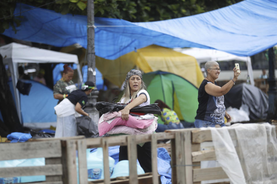 Supporters of former Brazilian President Jair Bolsonaro break camp outside a military base in Rio de Janiero, Brazil, Monday, Jan. 9, 2023, the day after Bolsonaro supporters stormed government buildings in the capital city of Brasilia. (AP Photo/Bruna Prado)