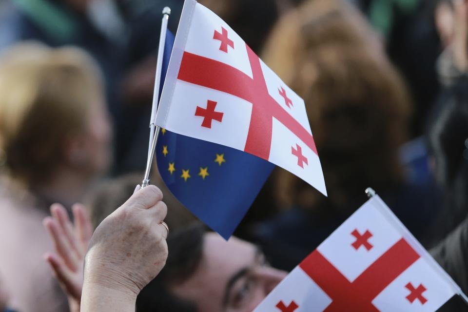 Georgians wave EU and national flags as they gather to celebrate Georgia's EU candidacy at Liberty Square in Tbilisi, Georgia, on Friday, Dec. 15, 2023. Several thousand people attend a march in support of Georgia's EU candidacy. European Union flags waved across Georgia Friday after the European Council took a step forward along the long road towards granting Georgia and Moldova as EU membership. (AP Photo/Zurab Tsertsvadze)