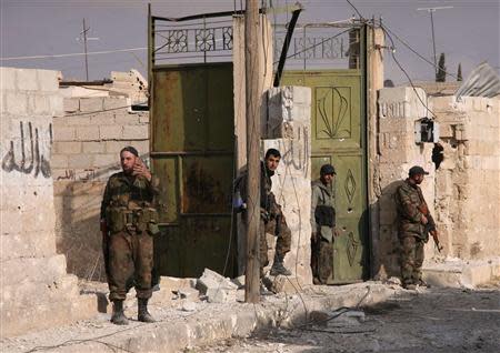 Forces loyal to Syria's President Bashar al-Assad carry their weapons as they stand in the town of Safira November 1, 2013. REUTERS/George Ourfalian