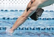 Apr 23, 2014; Mesa, AZ, USA; Michael Phelps dives in for the first time during a practice session for the Arena Grand Prix swim meet at Skyline Aquatic Center. Rob Schumacher-USA TODAY Sports