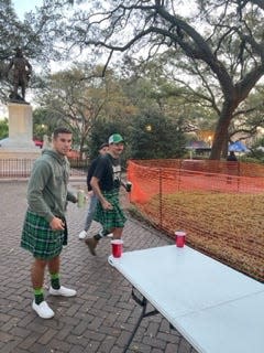 Will Kelly (right) plays a game of beer pong with friends.