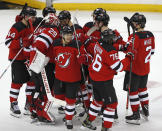 New Jersey Devils players celebrate after defeating the Columbus Blue Jackets 4-3 in a shootout in an NHL hockey game, Sunday, Feb. 16, 2020, in Newark, N.J. (AP Photo/Kathy Willens)