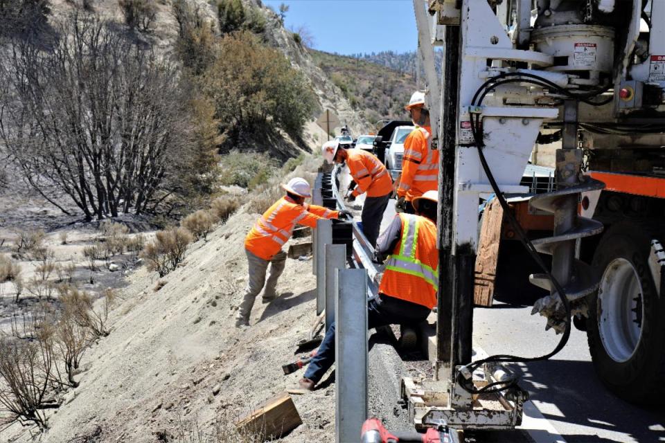 Caltrans crews on Wednesday worked to get Highway 2 reopened after the Sheep Fire swept through the area near Wrightwood.
