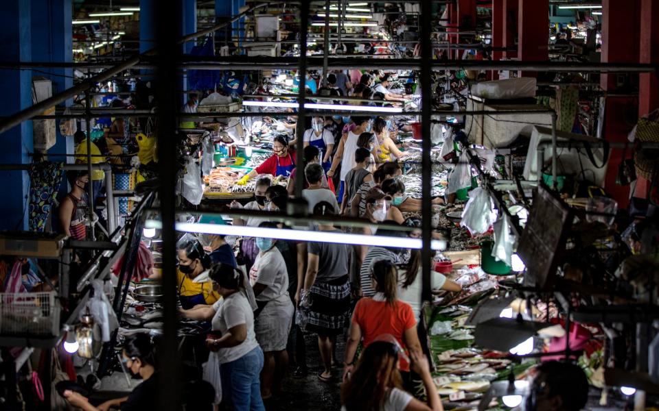 Filipinos flock a wet market to stock up on food a day before a strict lockdown is reimposed in Manila and nearby provinces on March 28, 2021 in Quezon city, Metro Manila, Philippines - Ezra Acayan 