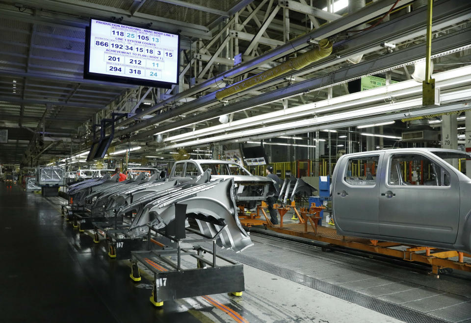 FILE- In this March 19, 2018, file photo truck chassis roll down an assembly line at Nissan's Canton, Miss., assembly plant. Nissan Motor Co. announced Thursday, Jan. 17, 2019, that it’s cutting up to 700 contract workers at its Mississippi assembly plant, citing slowing sales for vans and Titan pickup trucks that it makes there. (AP Photo/Rogelio V. Solis, file)