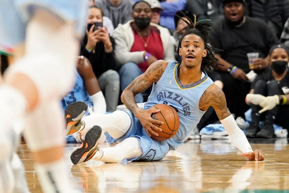 Jan 26, 2022; San Antonio, Texas, USA; Memphis Grizzlies guard Ja Morant (12) looks to pass the ball from the floor during the first half against the San Antonio Spurs at AT&T Center. Mandatory Credit: Scott Wachter-USA TODAY Sports