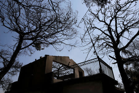 A burned house is seen following a wildfire near the village of Kalamos, north of Athens, Greece, August 14, 2017. REUTERS/Costas Baltas