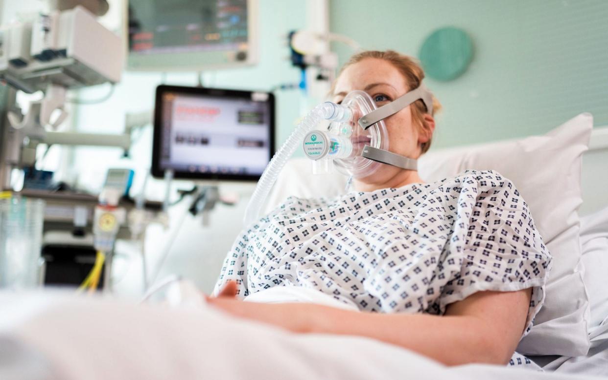 A volunteer patient uses the Continuous Positive Airway Pressure breathing aid - AFP