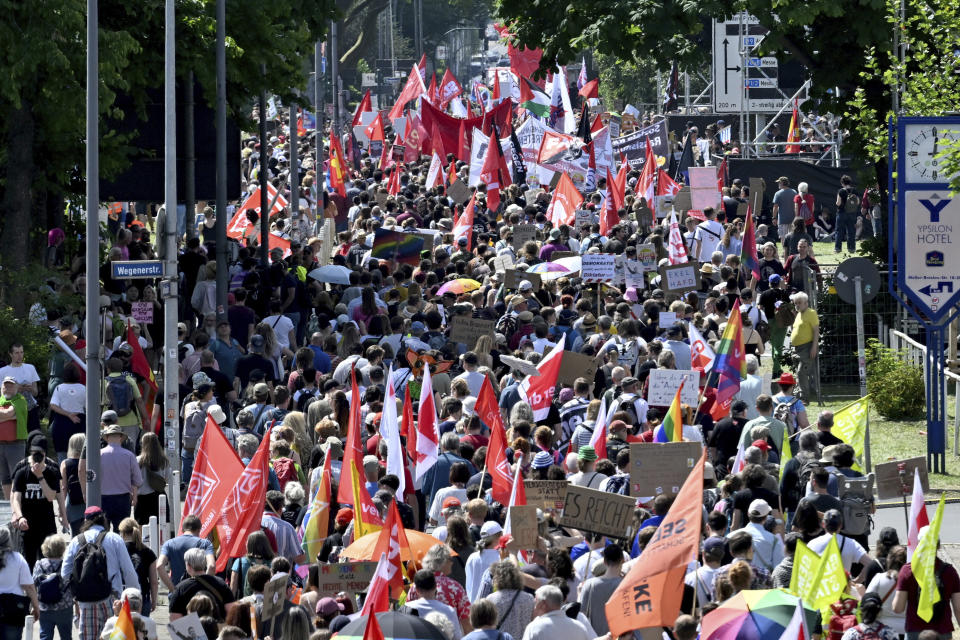 People gather to demonstrate against the AfD national party conference in Essen, Germany, Saturday June 29, 2024. The far-right Alternative for Germany party is holding a convention in the western city of Essen and large-scale protests against the party are taking place. (Henning Kaiser/dpa via AP)