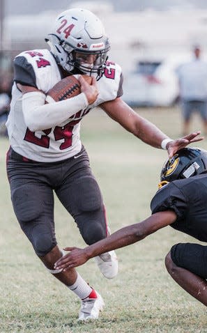 Barnsdall High running back Easton Malone powers past a would-be tackler during football action last fall. Malone is a three-sport athlete and is headed later this month to North Dakota for the USA Wrestling national championships.