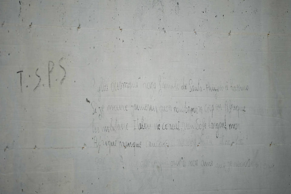 Writings left by Ousmane Sylla, a 21-year-old Guinean, are seen on a wall of the Ponte Galeria center in Rome, Tuesday, March 19, 2024, at the site of his apparent suicide. He was held in one of the facilities created in Italy to detain migrants ahead of their repatriation, as they are considered ineligible for refugee status or international protection, (AP Photo/Andrew Medichini)