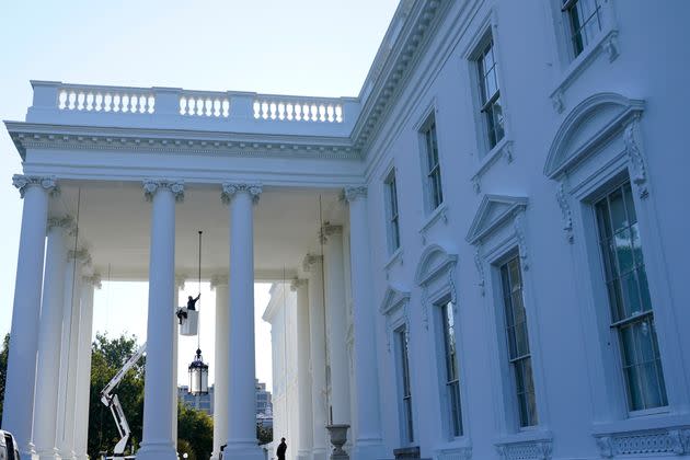 A worker works on the light fixture over the North Portico of the White House in Washington, Friday, Sept. 3, 2021. (AP Photo/Susan Walsh) (Photo: via Associated Press)