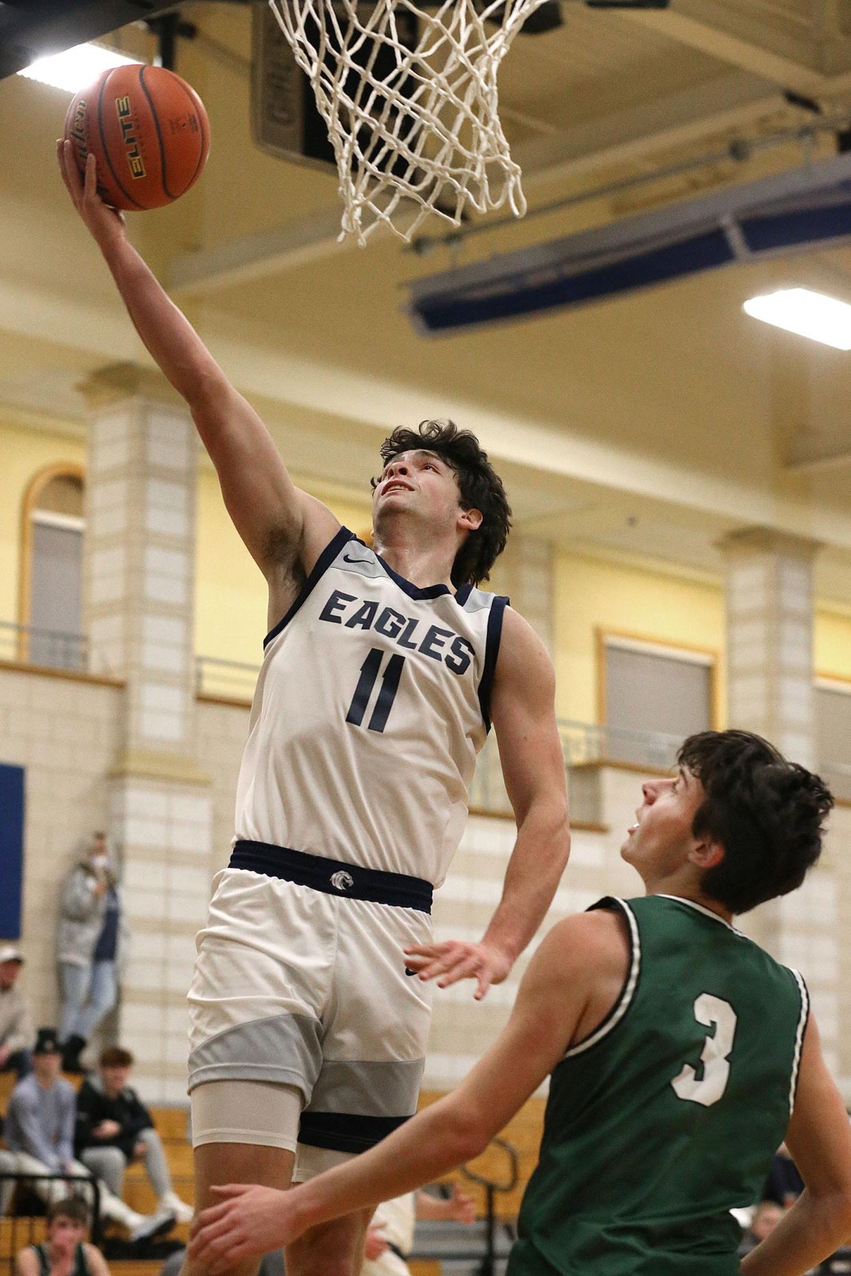 Laying up for two is Eagle #11 Cody Quinn.Plymouth North hosted Duxbury in boys basketball action on Friday February 3, 2023 