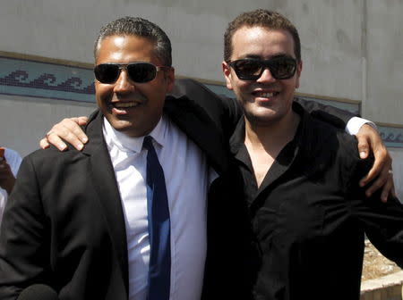 Al Jazeera television journalists Mohamed Fahmy (L) and Baher Mohamed hug as they talk to the media outside Tora prison, in Cairo, Egypt, July 30, 2015. REUTERS/Asmaa Waguih